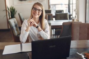 Professional lady smiling from behind a desk