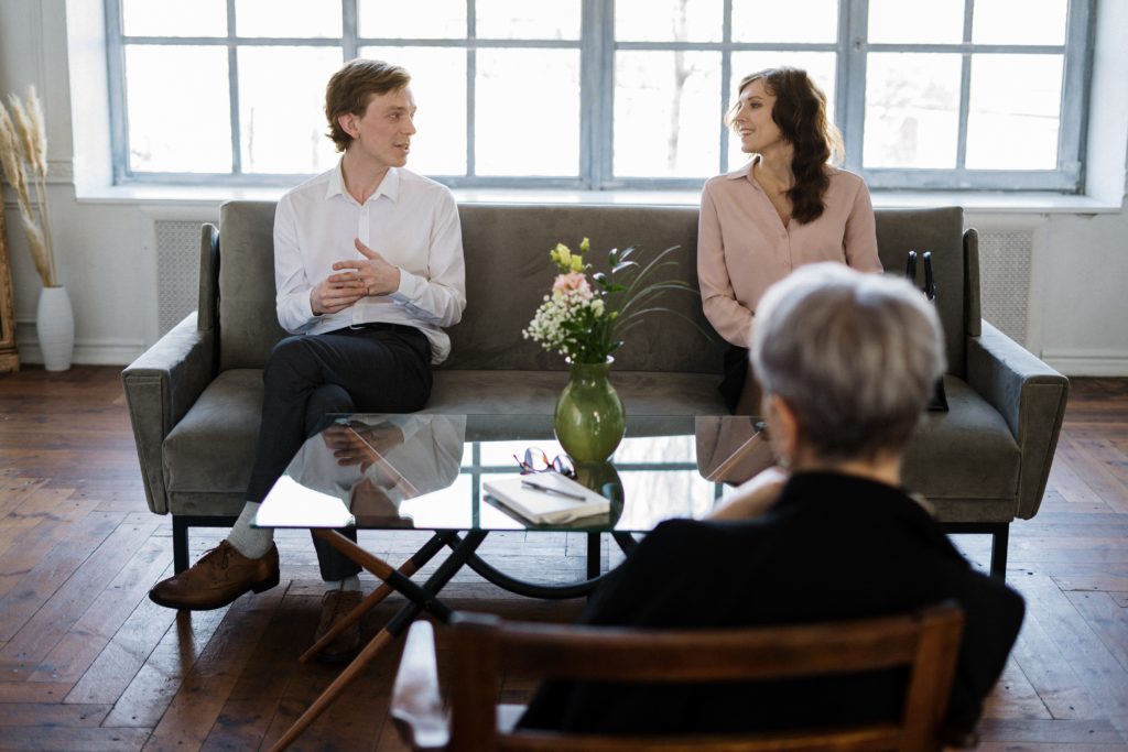 Couple talking to another person across the table